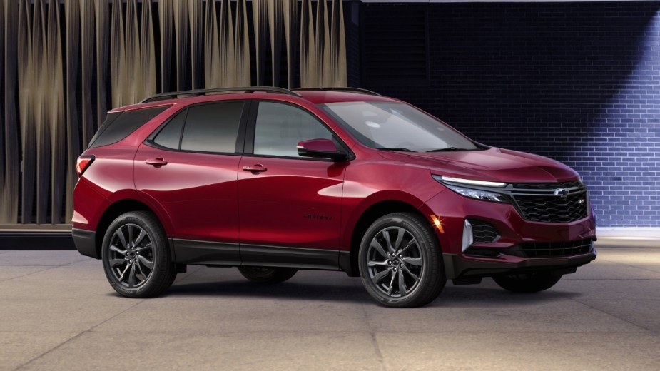 Front angle view of Cherry Red Tintcoat 2023 Chevy Equinox crossover SUV