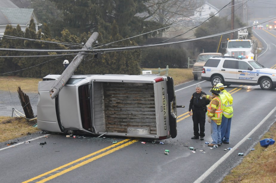 a white pickup on its side