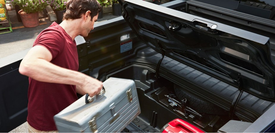 A 2022 Honda Ridgeline under bed storage container. Perfect for a tailgate party before a football game.