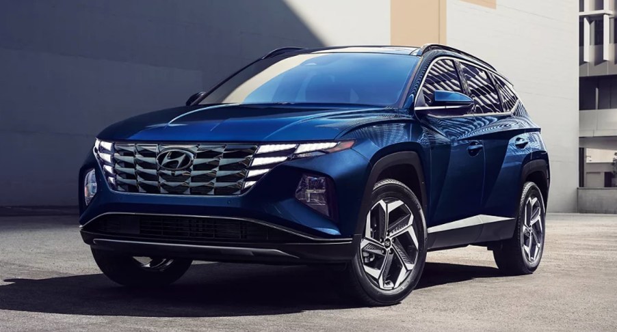 A blue Hyundai Tucson Hybrid small SUV is parked.