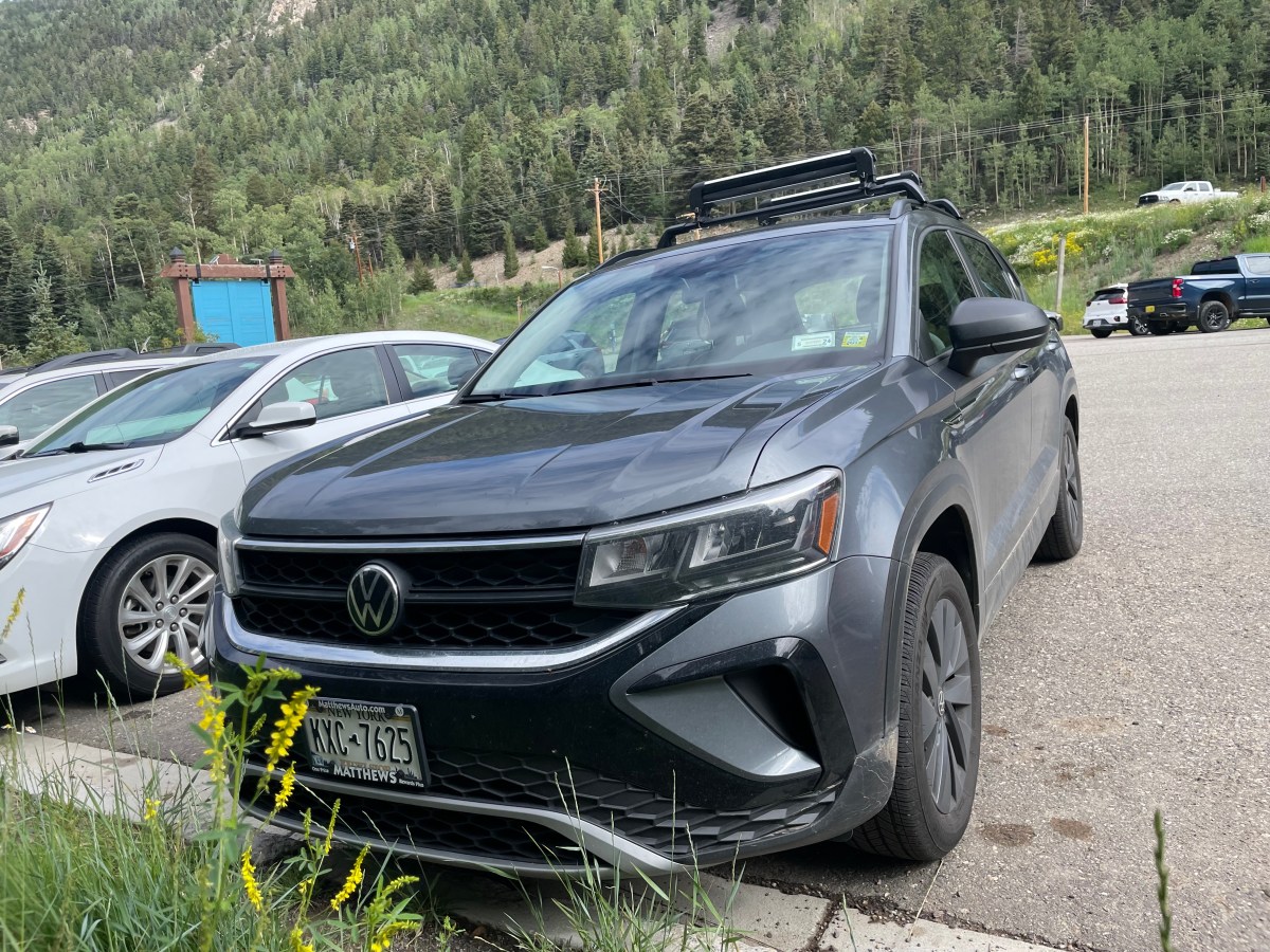 A dark gray VW Taos SUV in the parking lot of the Taos Ski Valley. 