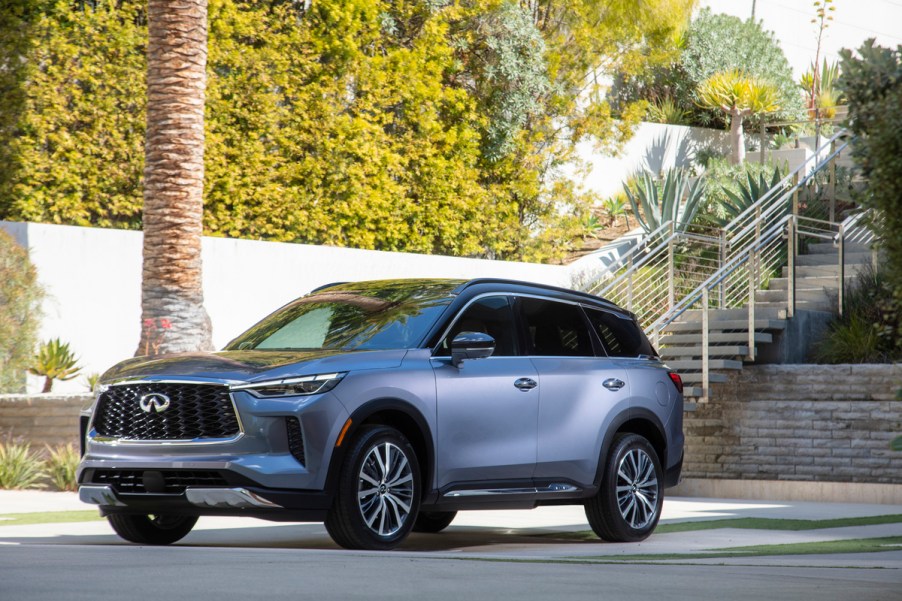 A silver 2022 Infiniti QX60 parked outside a house.