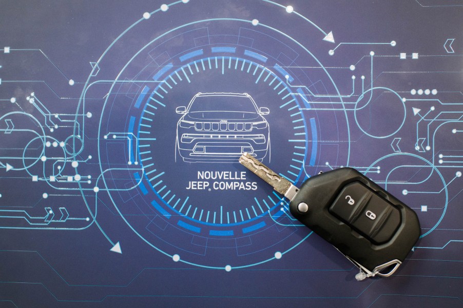 A depiction of a Jeep Compass in the form of a blueprint picture with a key fob.