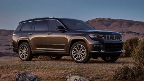 A green Jeep Grand Cherokee midsize SUV is parked outdoors.