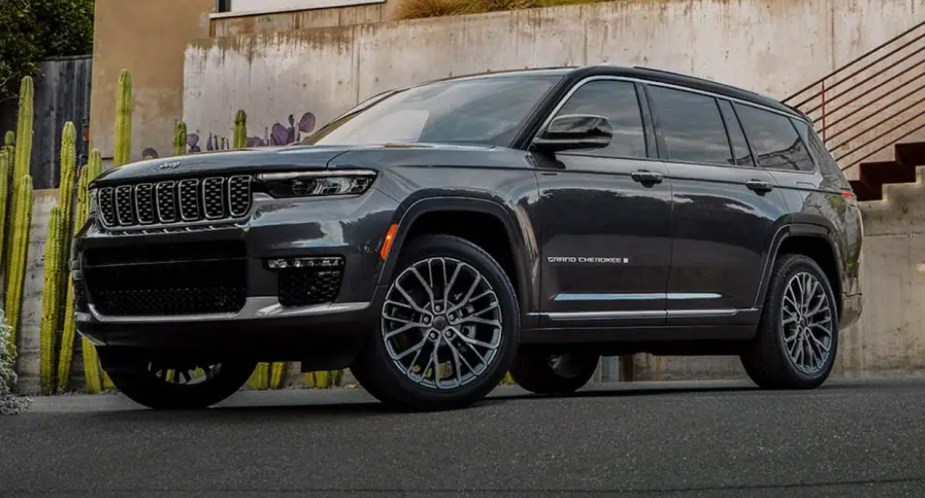 A green Jeep Grand Cherokee midsize SUV is parked. 