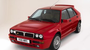 A red 1993 Lancia Delta HF Integrale Evoluzione (Evo) in a white studio