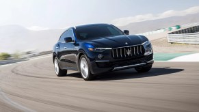 A blue 2022 Maserati Levante driving around a race track.