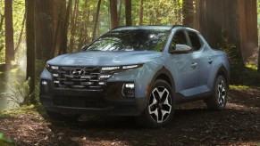 Light blue 2023 Hyundai Santa Cruz parked in a forest