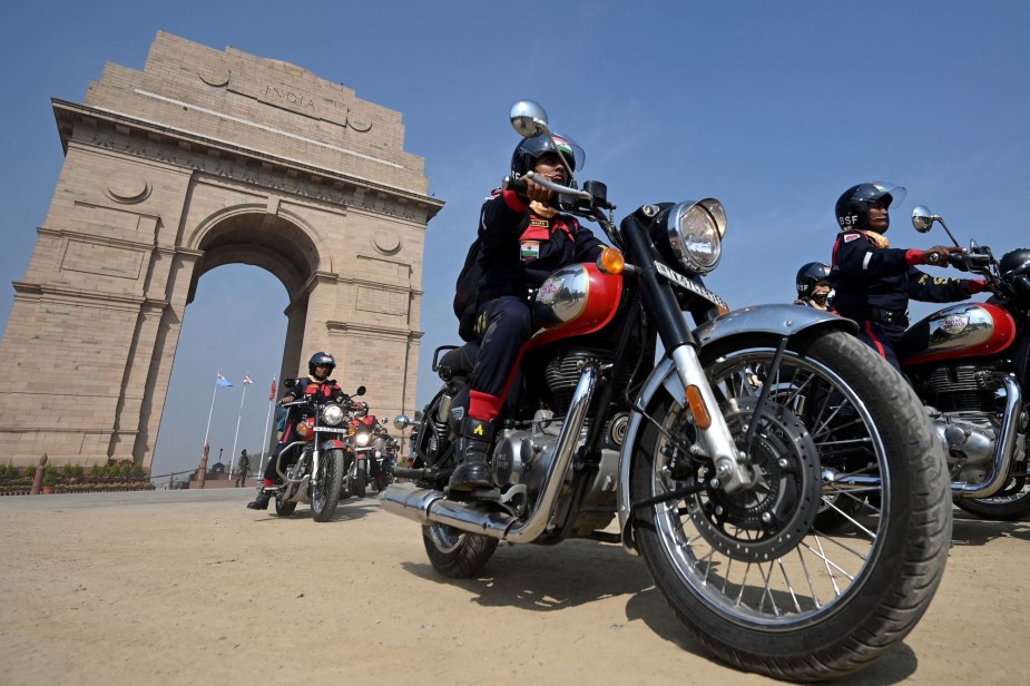 People riding on a potentially customized bike. 