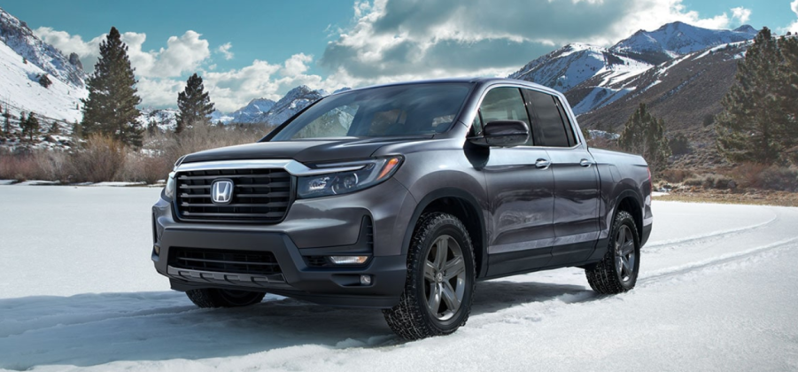 A 2023 Honda Ridgeline sits in a snowy mountain range. What kind of fuel economy does it have?