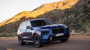 a blue 2022 BMW x7 on a mountain road