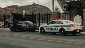 Police officer by driver, highlighting why cops touch the back of cars during traffic stops