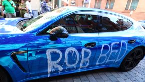 Vandalism spray paint on a blue Porsche supercar model in London, U.K.