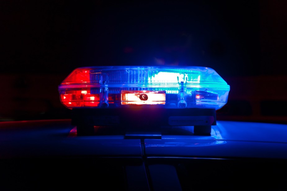 Closeup of a red and blue light bar on the roof of an emergency vehicle.