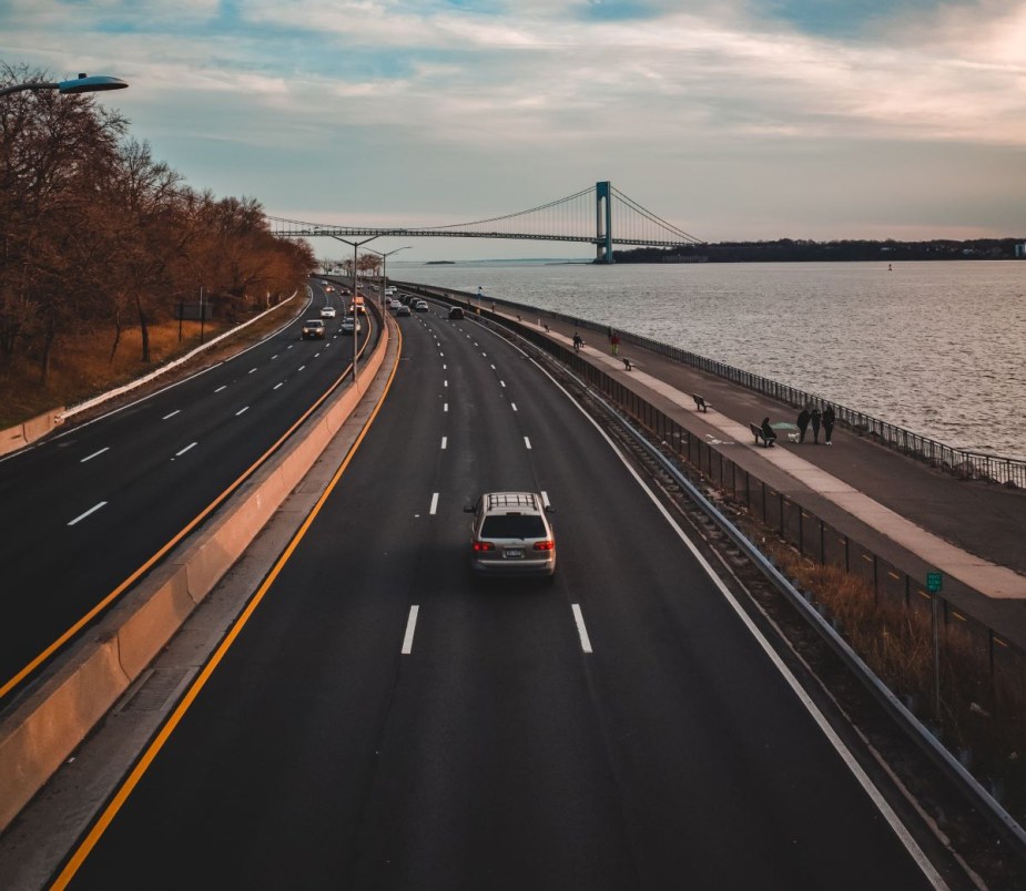 SUV driving on a New York highway, highlighting why cars are bigger in U.S. compared to other countries