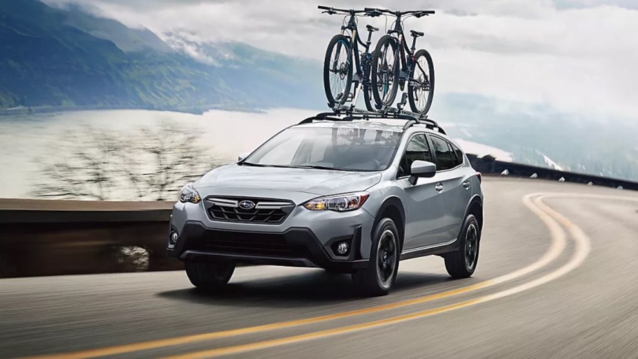 Silver 2023 Subaru Crosstrek crossover SUV driving on a coastal road