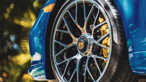 Tire on a blue car, highlighting how tire particles that shed pollute the water and harm the environment