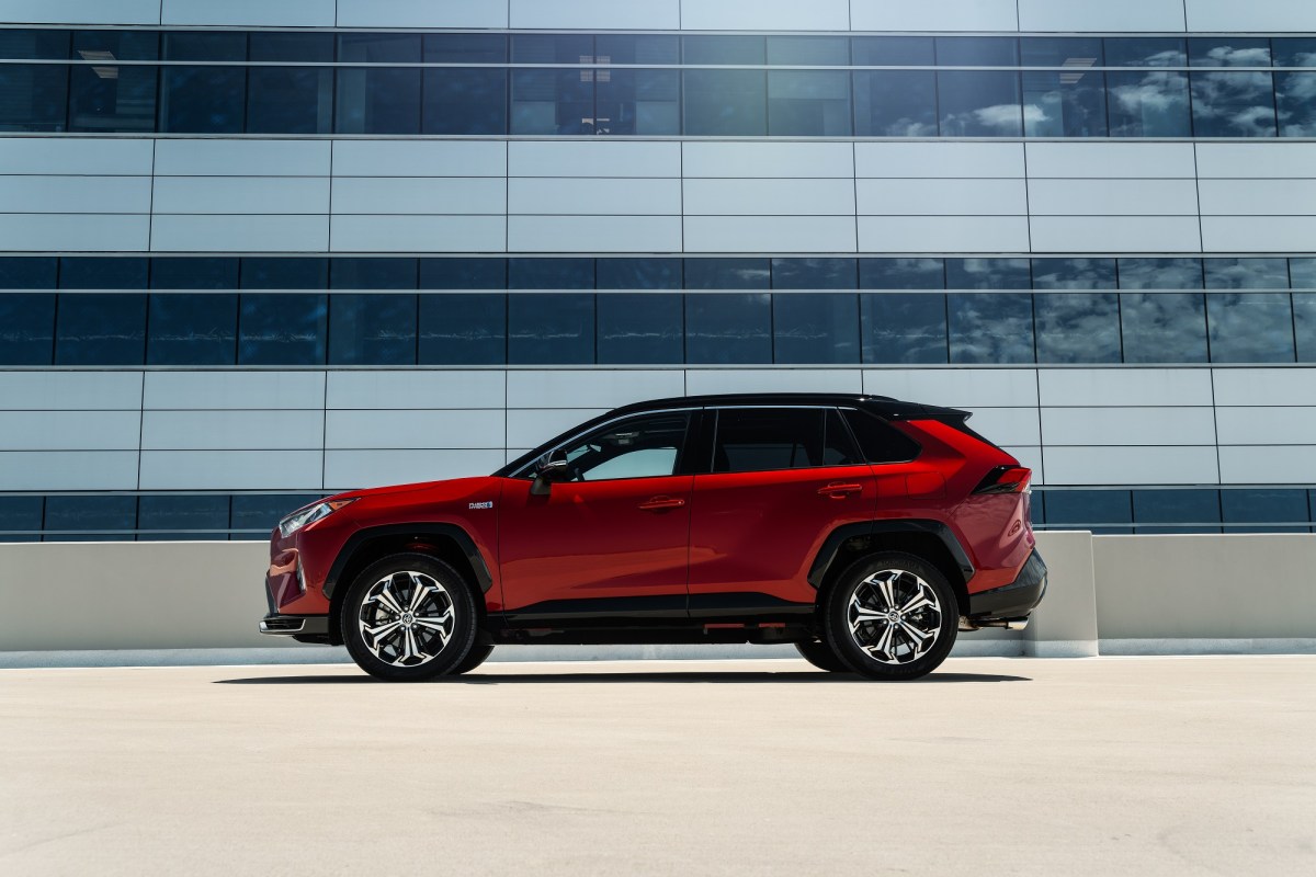 A red Toyota RAV4 Prime Small SUV parked near an office building