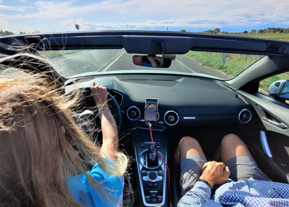 Woman with messy hair driving car, highlighting how a car is the best place to talk about challenging situations