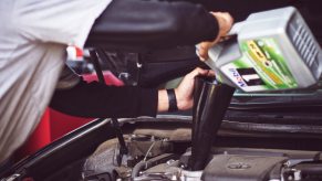 A man performing vehicle maintenance and an oil change on a car