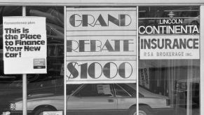 Car finance and lease signs at a Lincoln Continental showroom in 1980