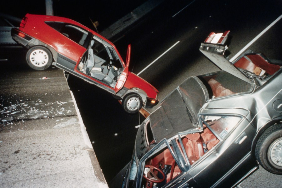 Cars on a damaged bridge after an earthquake.