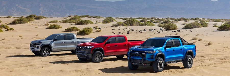 a trio of 2023 Chevy Colorado trucks in the desert