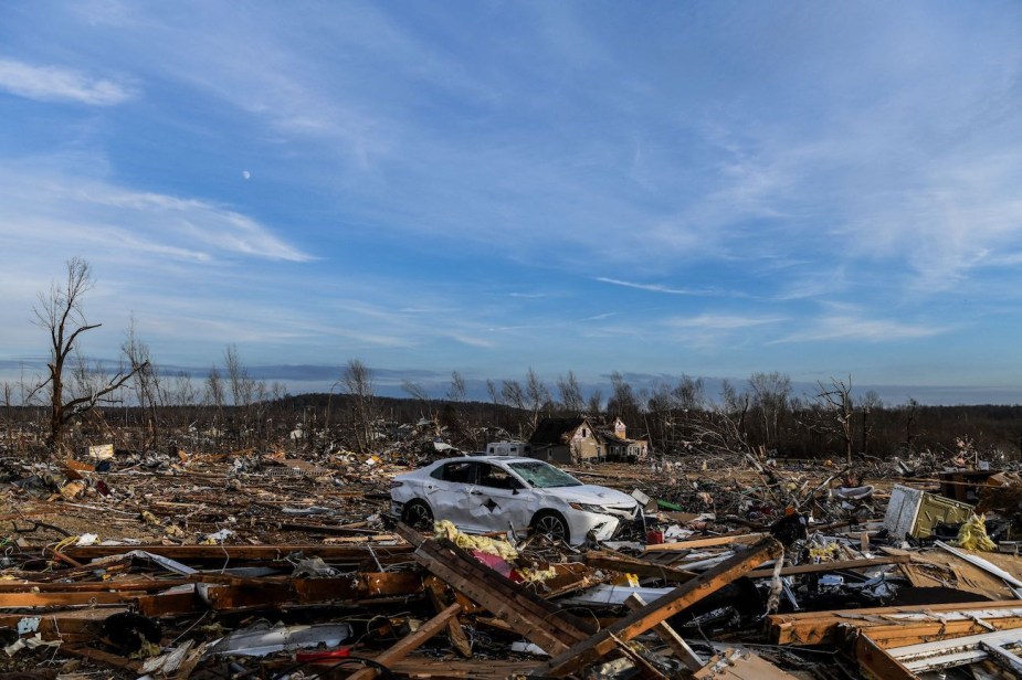 Debris of a destroyed home and a car after a tornado.