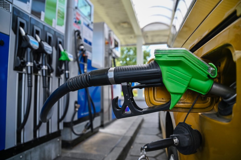 A green gas pump in a vehicle. 