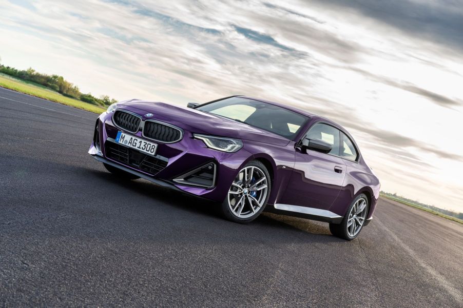 A purple Thundernight Metallic BMW 2 Series M240i XDrive Coupe sports car model