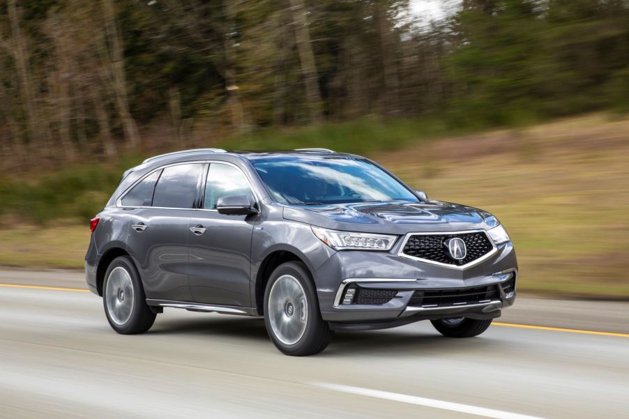 A gray 2017 Acura MDX Sport Hybrid midsize luxury crossover SUV model driving on a highway