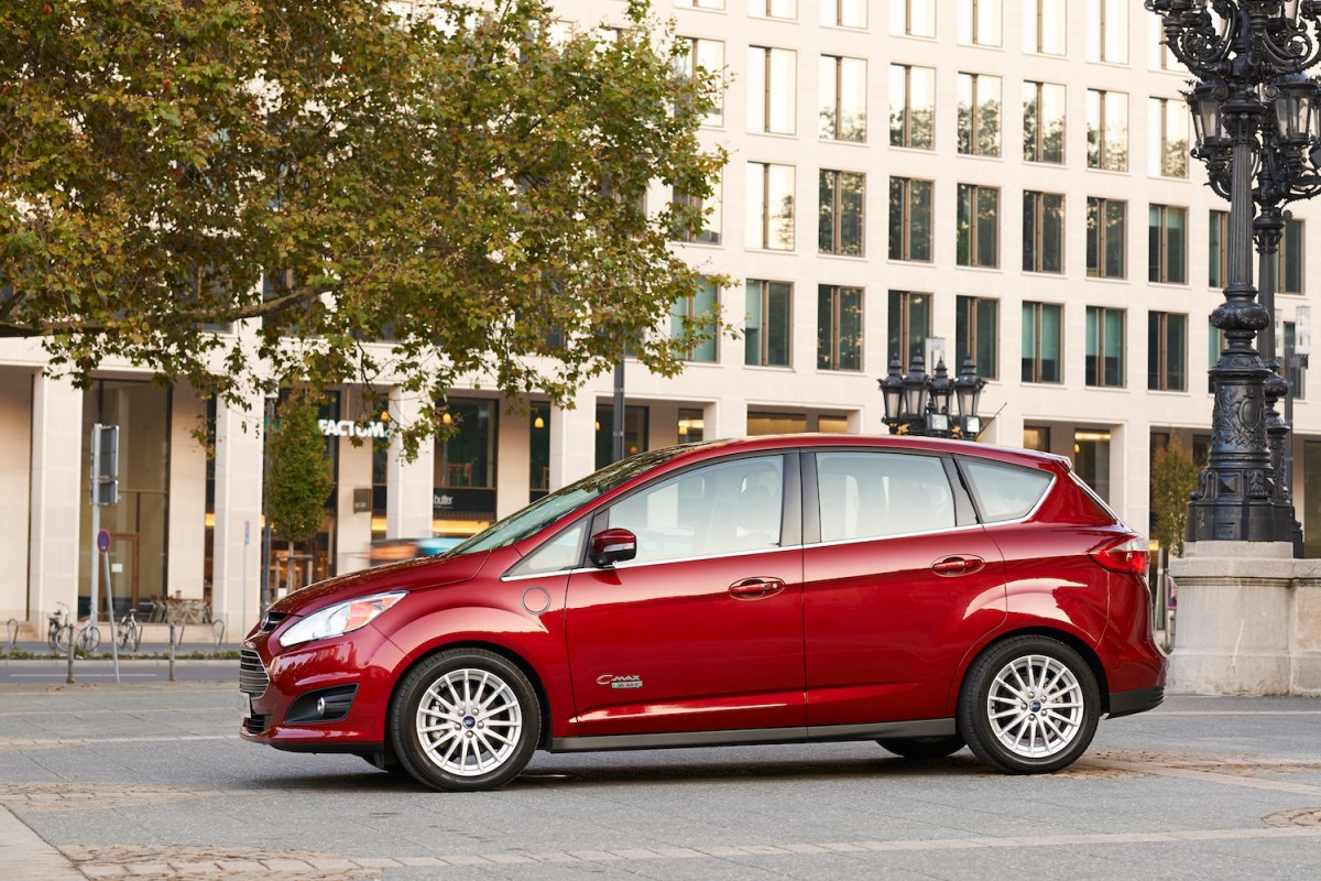 A red C-MAX Energi plug-in hybrid vehicle parked