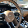 The steering wheel and center console view in the 2022 Jaguar F-Pace S.