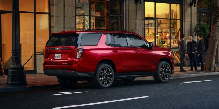 A red 2022 Chevy Tahoe RST parked on the street. Experts recommend it over the most popular trim.