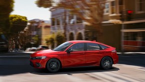 A red 2022 Honda Civic hatchback driving