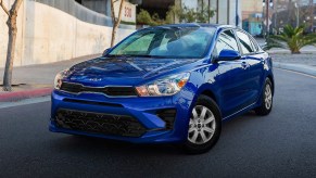 A blue 2022 Kia Rio driving