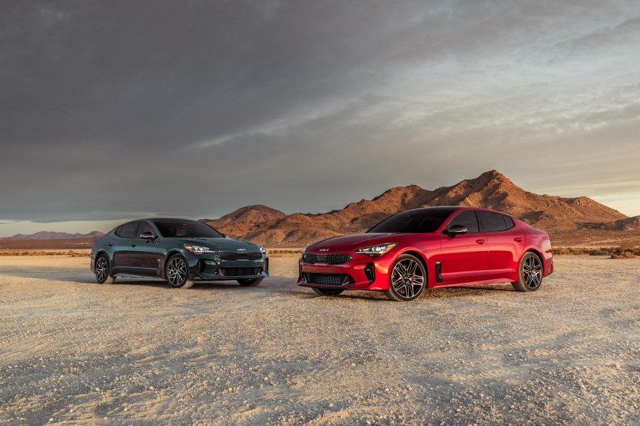 A red and black 2022 Kia Stinger parked in the dessert.