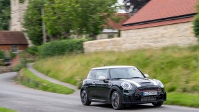 A 2022 Mini Cooper driving through a town.