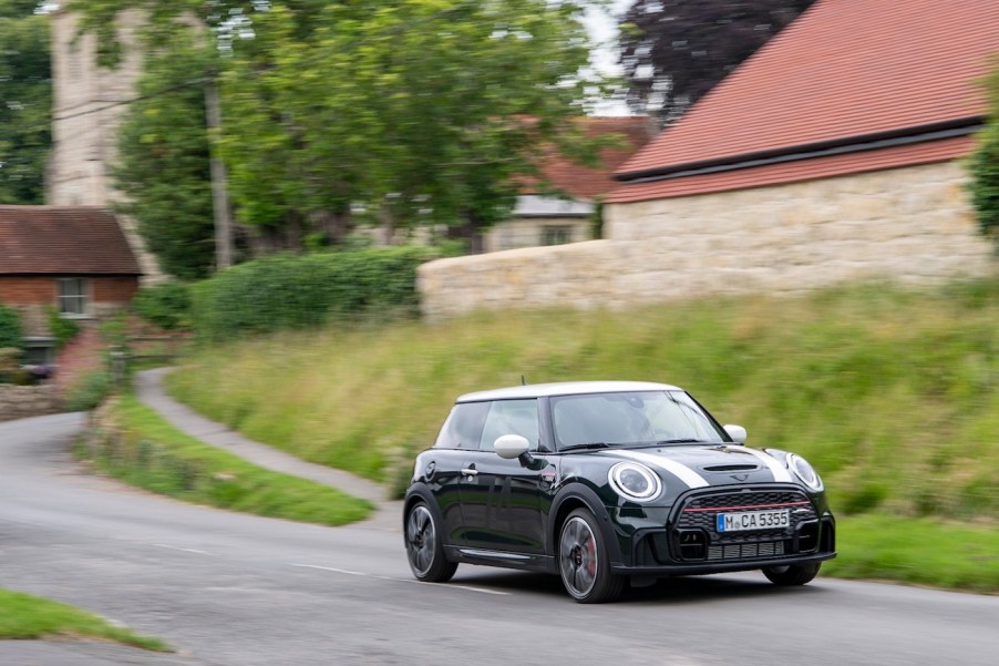 A 2022 Mini Cooper driving through a town.