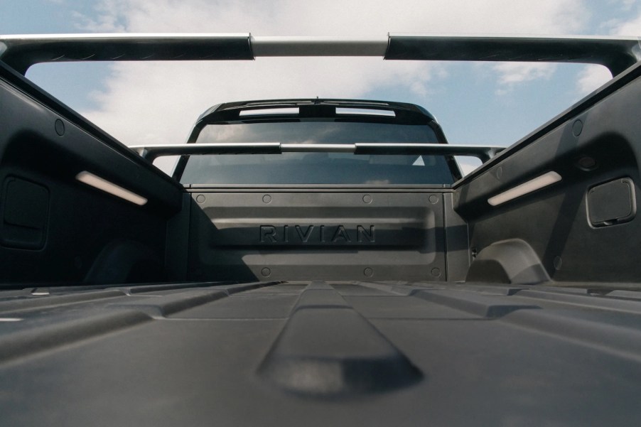 The bed of a Rivian R1T electric pickup truck, complete with outlets.