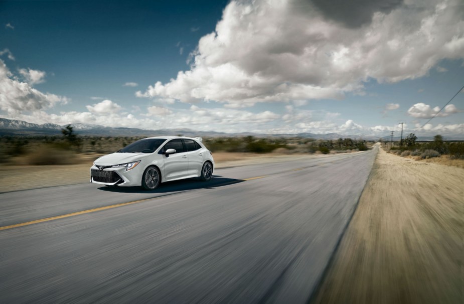 A white 2022 Toyota Corolla Hatchback driving