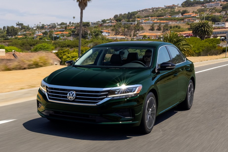 The 2022 Volkswagen Passat driving down a road.