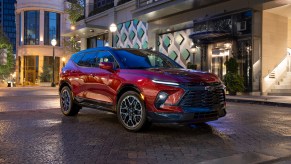 A red 2023 Chevy Blazer RS in a city area.