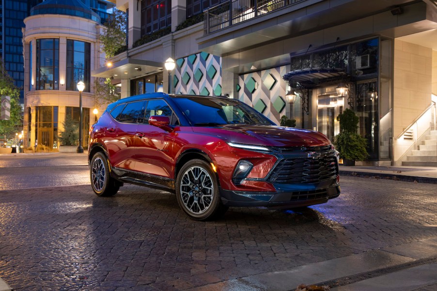 A red 2023 Chevy Blazer RS in a city area.