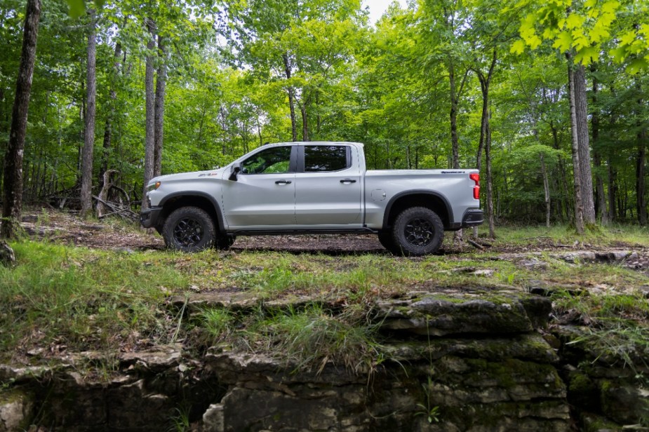 Side view of a white 2023 Chevrolet Silverado ZR2 Bison in the woods