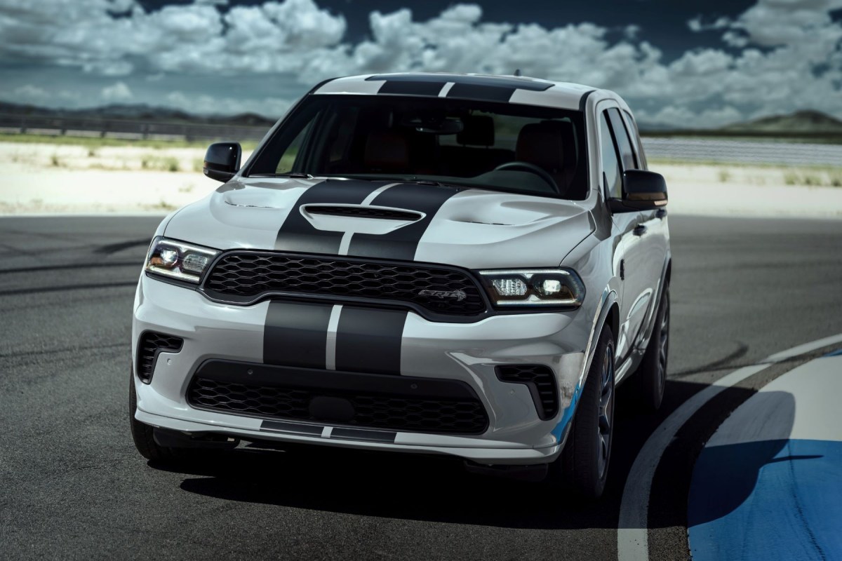 A 2023 Dodge Durango midsize SUV with a hood vent and racing stripe on a racetrack