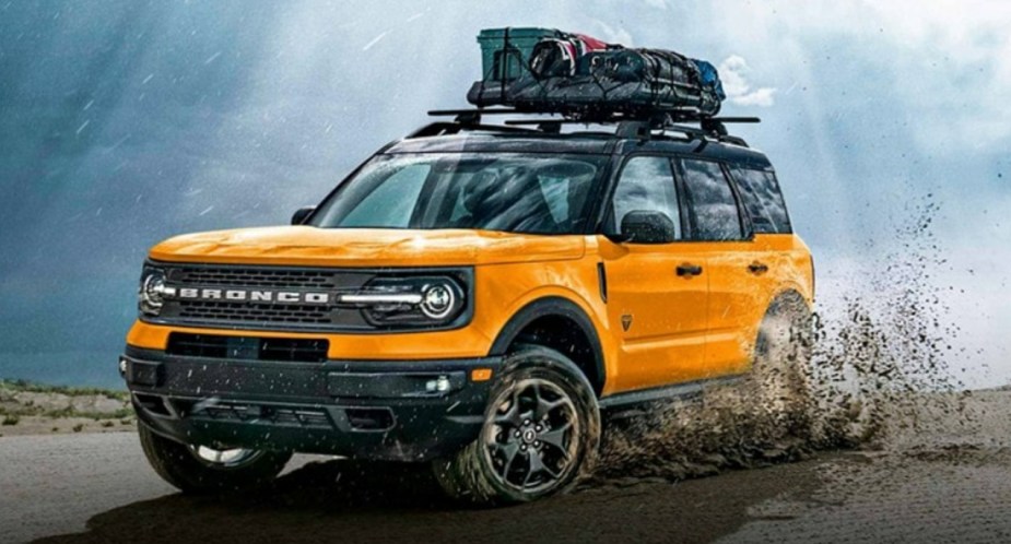 A yellow 2023 Ford Bronco Sport is driving off-road. 