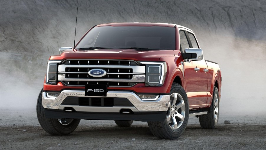 Red 2023 Ford F-150 kicking up dust on the trails