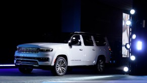 A white 2023 Jeep Grand Wagoneer parked indoors.