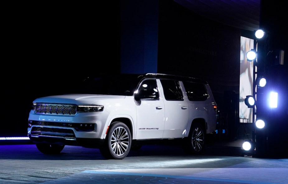 A white 2023 Jeep Grand Wagoneer parked indoors. 